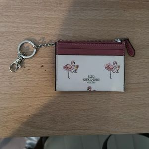A flamingo Coach card holder